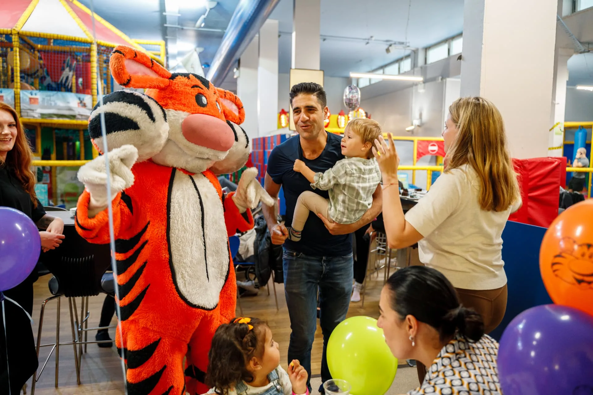 Gambado the Tiger meeting children at a birthday party with balloons